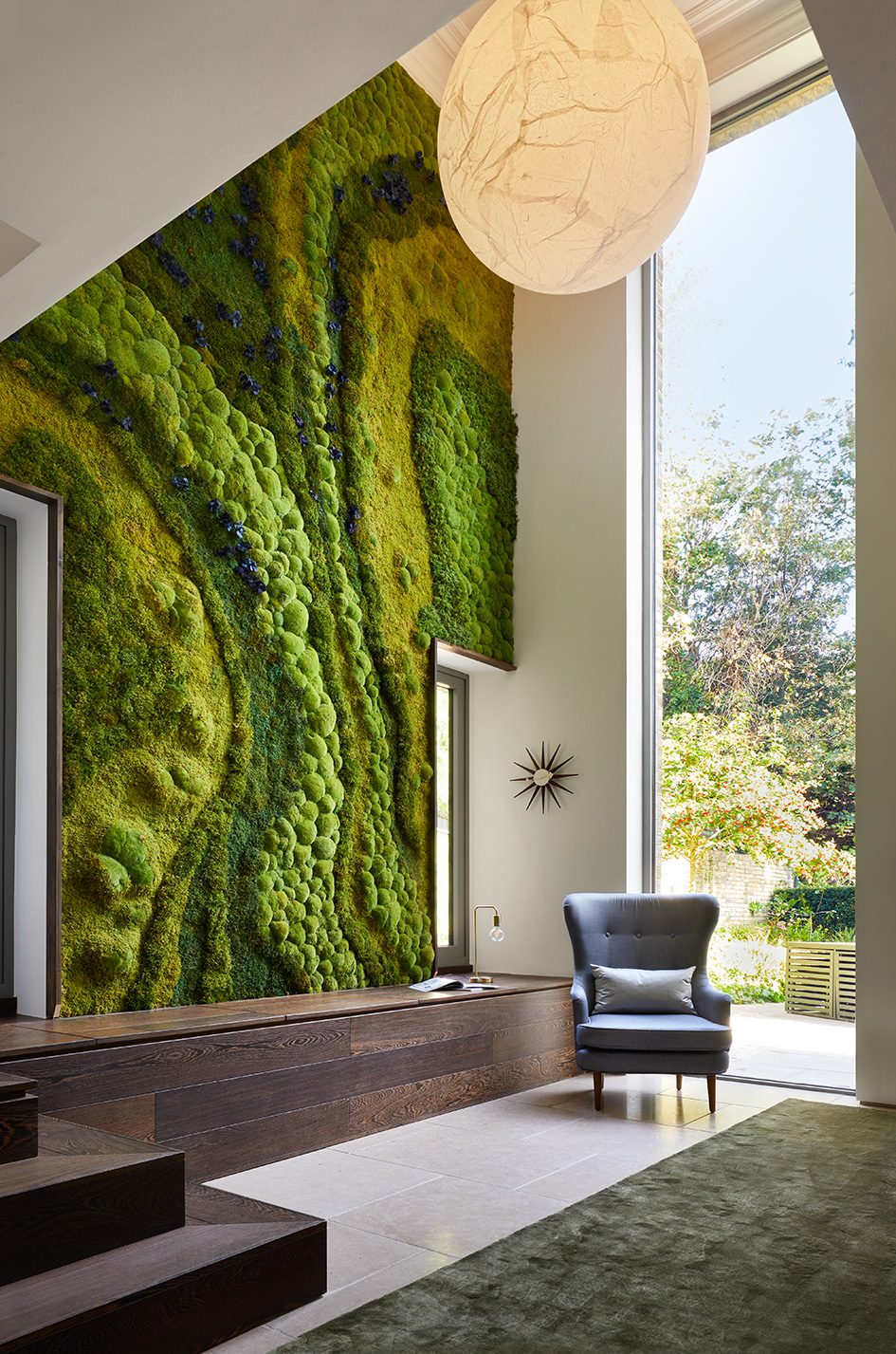 Double height moss wall in a contemporary Victorian home